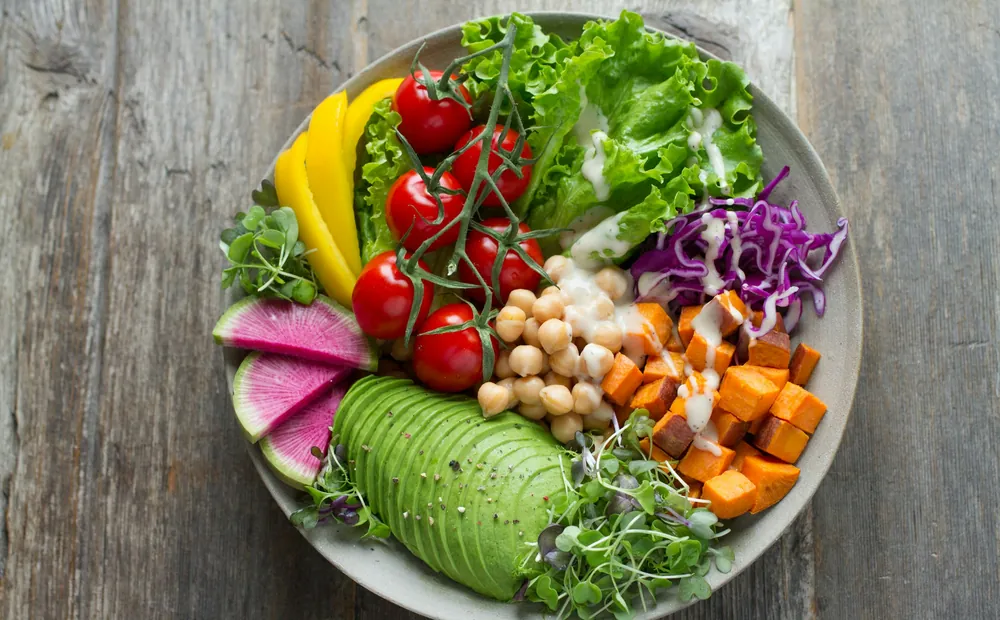 A fiber-rich bowl of greens, chickpeas, avocado and roasted vegetables