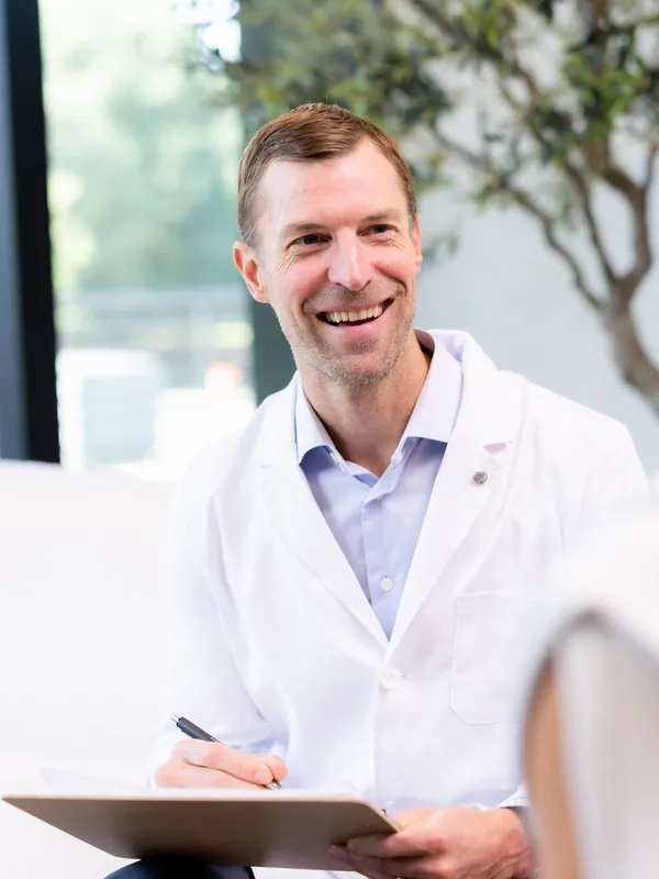 Dr. Josh Axe in a consultation with a patient at The Longevity Club + Clinic in Franklin, TN